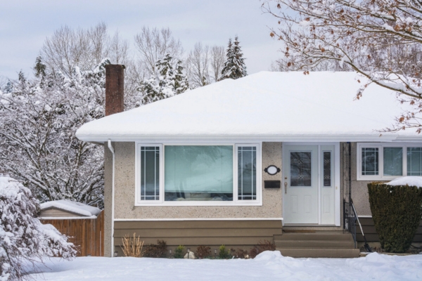 family house covered in snow depicting freezing temperatures