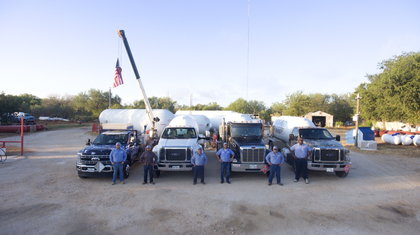 Staples, TX team of technicians with delivery trucks and propane tanks at service yard