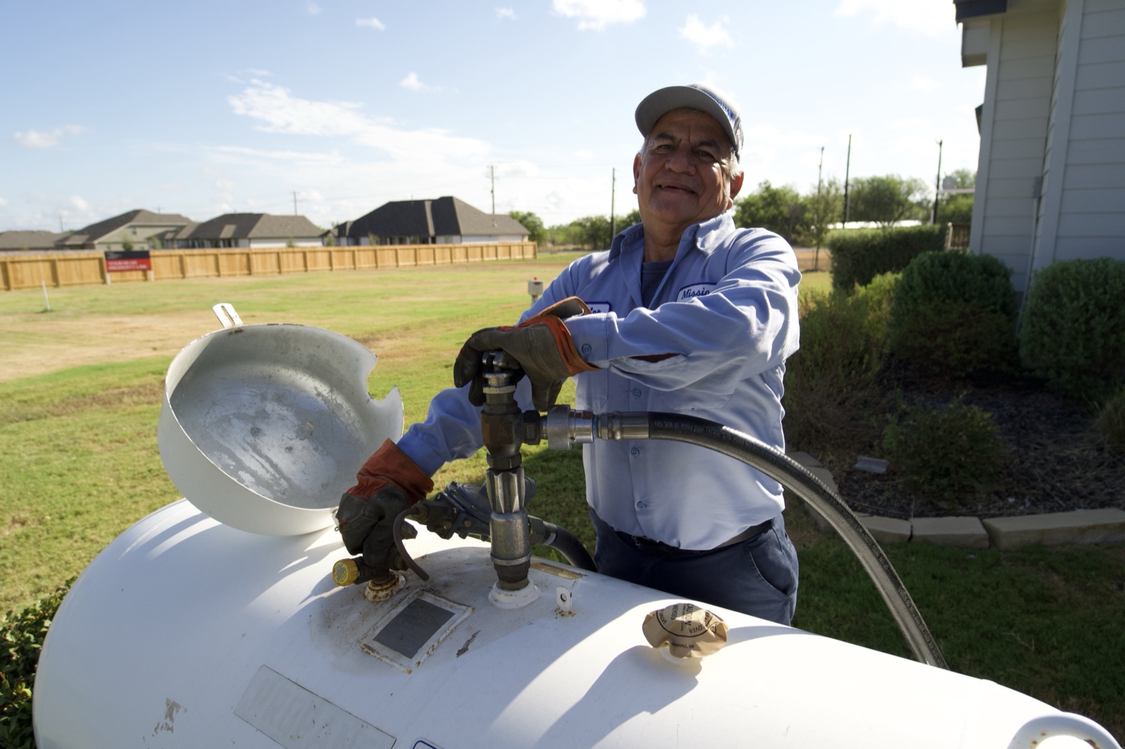 Staples, TX technician delivering propane to a residential propane tank